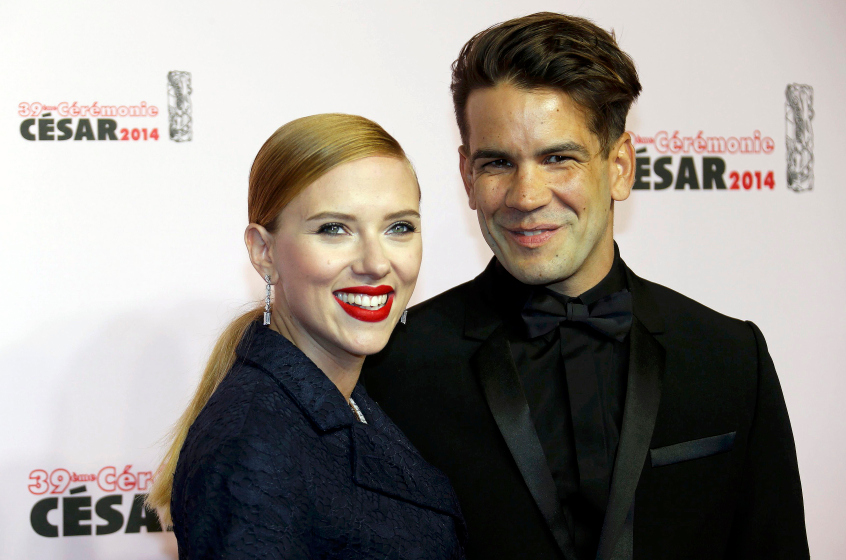 US actress Scarlett Johansson and her partner Romain Dauriac pose as they arrive for the 39th Cesar Awards ceremony in Paris